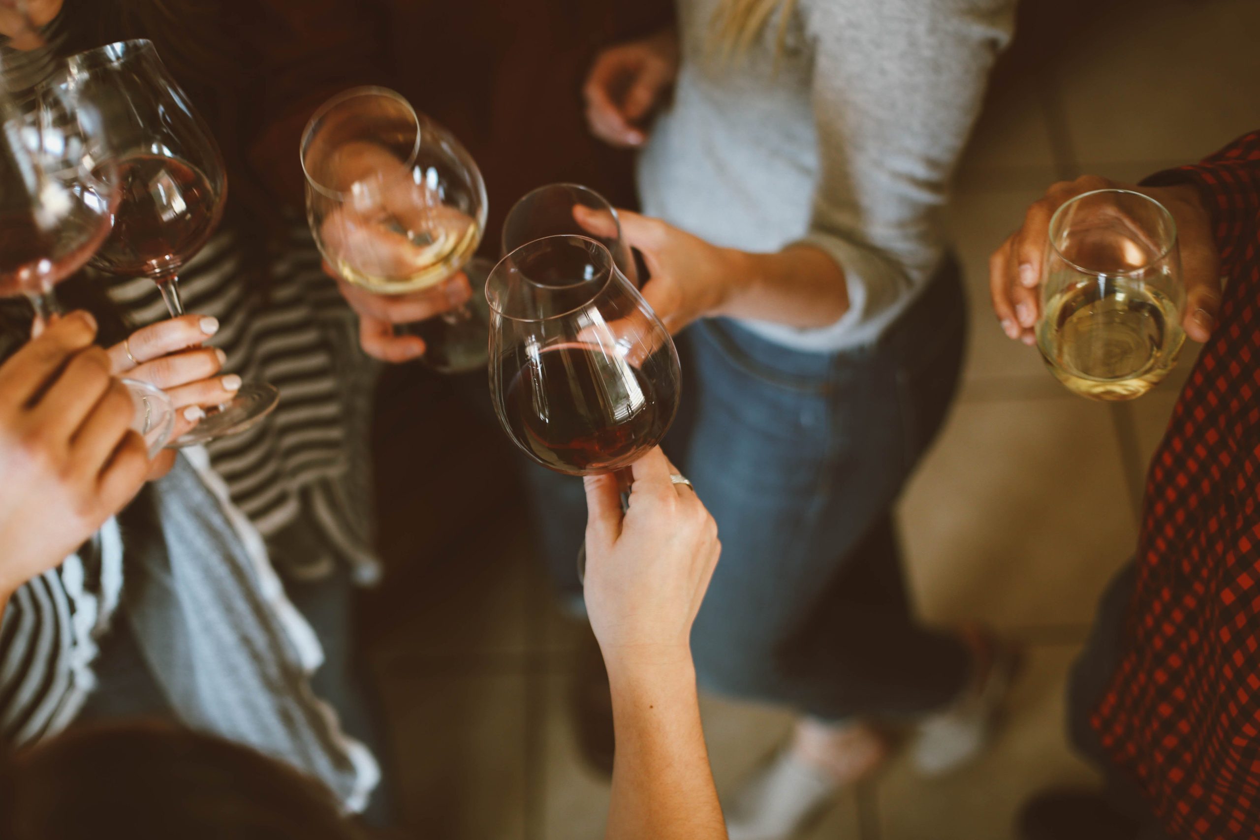 Einige Leute stoßen Abends mit Wein an